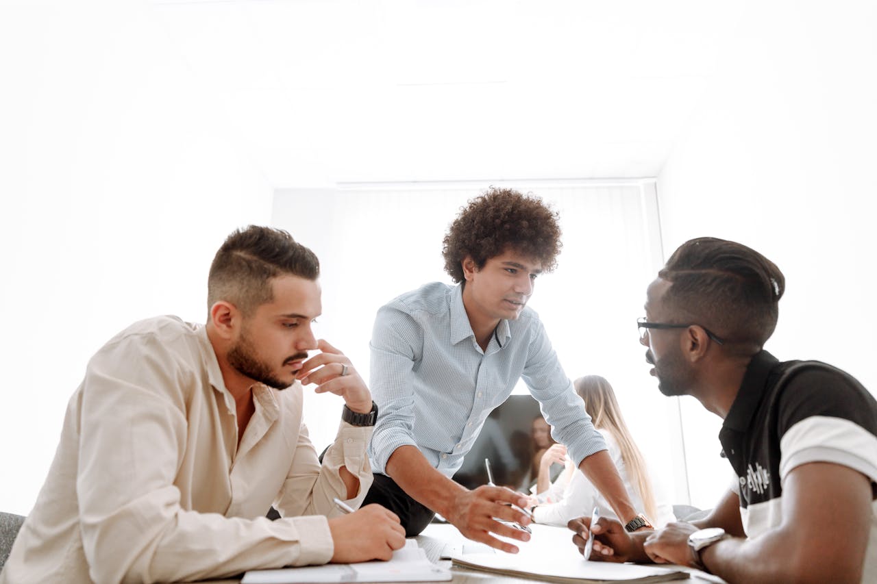 Services-03 Diverse group of young professionals engaged in a collaborative office meeting.